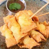 Giaw Tod · Crispy fried wontons stuffed with fish balls served with spicy tamarind sauce