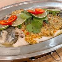 Pla Ma Nao · Steamed whole seabass with cabbage, lemongrass, galangal, lime leaves topped with house spec...