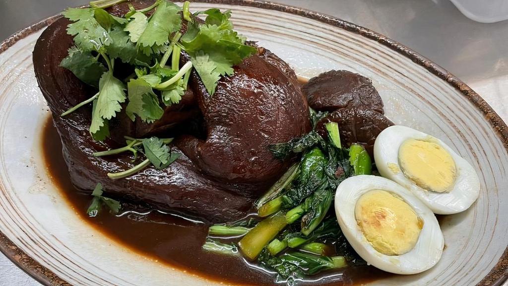 Kha Moo · Stewed pork knuckle in sweet 5-spice soy sauce served with mushroom, Chinese broccoli, boiled egg ,and garlic chili vinaigrette