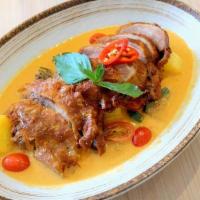 Kang Ped · Half roasted duck in coconut red curry sauce with tomato, pineapple, eggplant, red pepper, a...