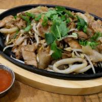 Kau Gai · Crispy fried flat noodles with chicken, squid, bean sprout, and eggs on hot plates served wi...