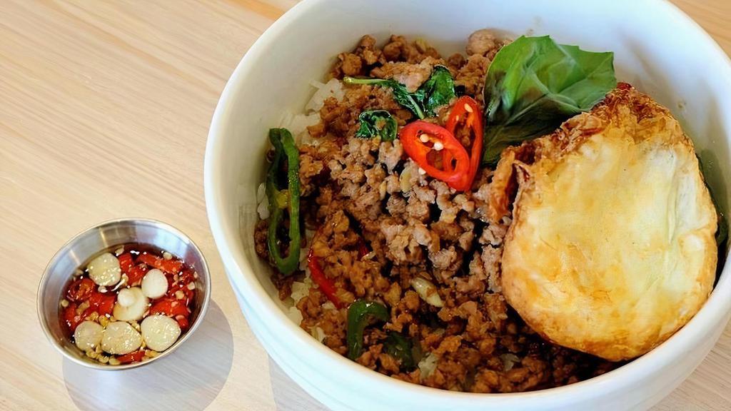 Kra Prow · Stir-fried ground pork with fresh chili, long hot pepper, red pepper, and basil over rice topped with fried egg
