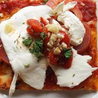 Crispino Pizza · Thin crust pie topped with sliced tomatoes, fresh mozzarella, roasted peppers, fresh garlic,...