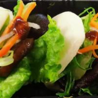 Buddha Bun · Shiitake mushrooms, lettuce, cucumber, julienne scallions with house special sauce (2 pcs/ ea)