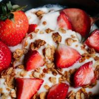 Yogurt Parfait · Layers of creamy Greek yogurt, fresh strawberries, and granola.