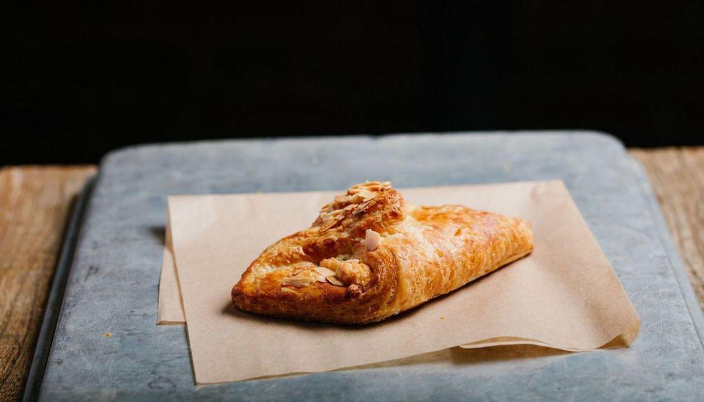 Almond Croissant · A buttery croissant filled with almond paste and  sprinkled with flaked almonds.