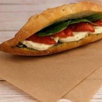 Caprese Baguette · Roasted tomatoes, mozzarella, and basil served on a baguette.