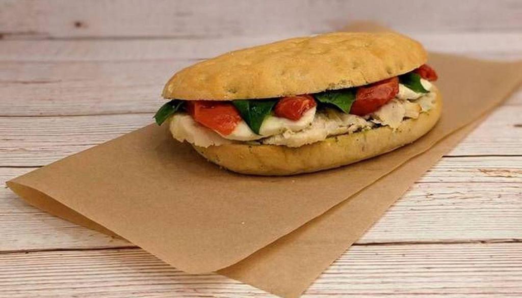 Chicken Caprese · Sliced chicken, basil pesto, roasted tomatoes, and fresh mozzarella on our Tuscan sandwich bread.