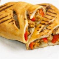 Sausage & Roasted Pepper Calzone · Crispy pizza dough filled with sweet sausage, roasted peppers, caramelized onions, and mozza...