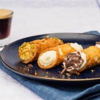 Cannoli · Classic Italian dessert with fresh ricotta cheese filling, dusted with powdered sugar and wi...
