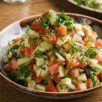 Shirazi Salad Dinner · Diced cucumbers, tomatoes, red onions, and parsley in lemon vinaigrette.