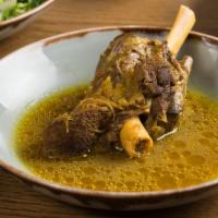 Lamb Shank Dinner · Colorado lamb shank simmered with herbs and garlic in tomato sauce. Served with green rice.