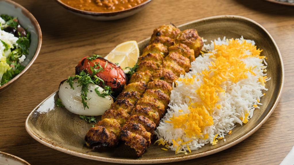 Chicken Koobideh Kebob Dinner · Two skewers of juicy chopped chicken flavored with saffron. Served with basmati rice, grilled onion, and tomato.