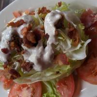 Wedge Salad · iceberg lettuce wedge with tomatoes, bacon bits & chunky blue cheese dressing