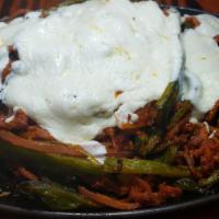 Spicy Pork Alambre · Spicy pork, 
chile poblano, onions, Oaxaca
cheese, rice, beans, and tortillas