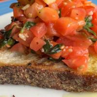 Bruschetta Al Pomodoro · with chopped tomatoes, basil, garlic, and olive oil on Tuscan bread.