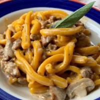 Casarecce Alla Norcina · Homemade pasta with sweet sausage, porcini mushrooms, and truffle-cream sauce.