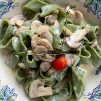 Spinach Pappardelle Con Funghi · Homemade pasta with crimini mushrooms and truffle-cream sauce.