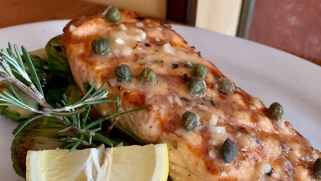 Salmone Alla Griglia · Grilled salmon filet with lemon, caper-butter sauce, and a side of sauteed spinach.