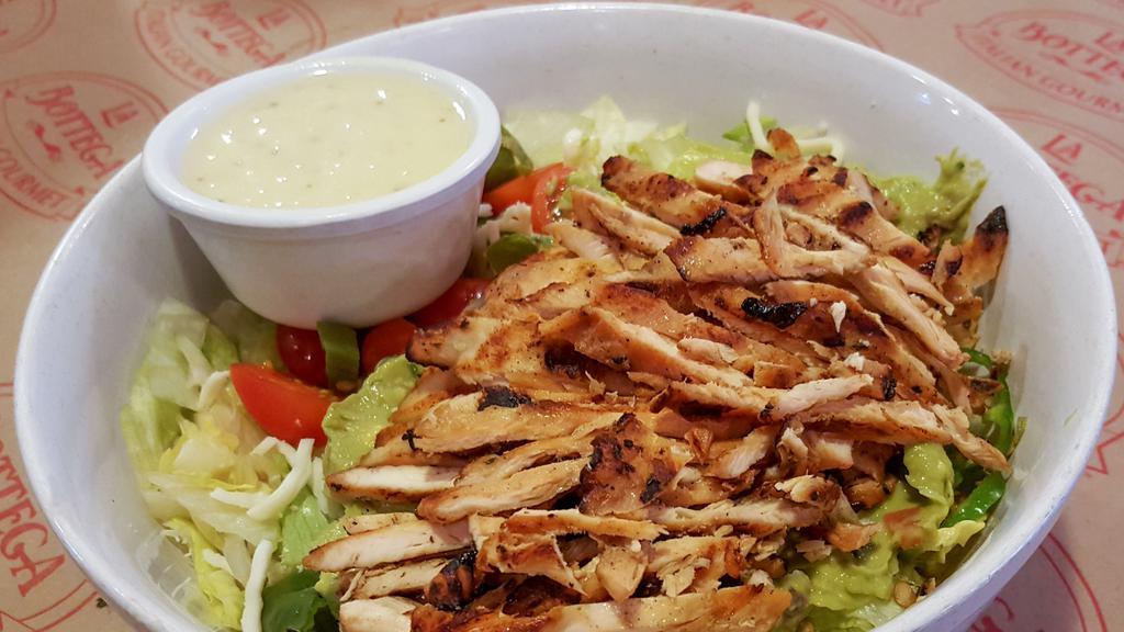 Pollo E Guacamole · Gluten Free Grilled chicken, iceberg lettuce ,guacamole, roasted hot peppers, shredded mozzarella and cherry tomatoes with lime dressing