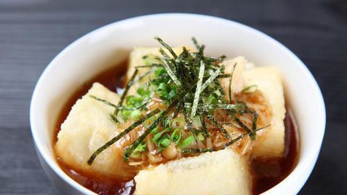 Age Tofu · Deep fried tofu with tempura sauce topped with dried bonito flake and shredded seaweed.