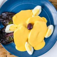 Papa Or Yuca A La Huancaina · Boiled potatoes or cassaba, spicy yellow pepper sauce, olives and eggs.