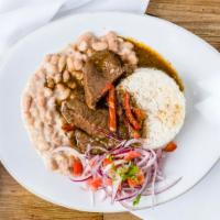 Seco De Carne · Beef cilantro stew, beans, salsa criolla and rice.