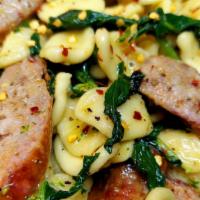 Orecchiette & Sausage · Fresh little ear pasta with olive oil, broccoli rabe & sweet Italian sausage. Topped with re...