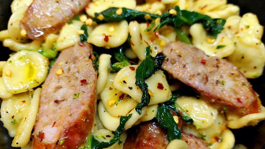 Orecchiette & Sausage · Fresh little ear pasta with olive oil, broccoli rabe & sweet Italian sausage. Topped with red pepper flakes.