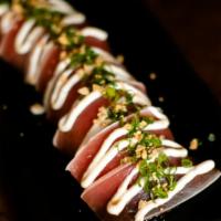 Ahi Tataki · Doraku favorites. Seared tuna served over a wakame daikon salad, garnished with garlic aioli...