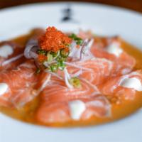 Salmon Carpaccio · Doraku favorites. Thinly sliced king salmon sashimi, red onions, garnished with a creamy gin...