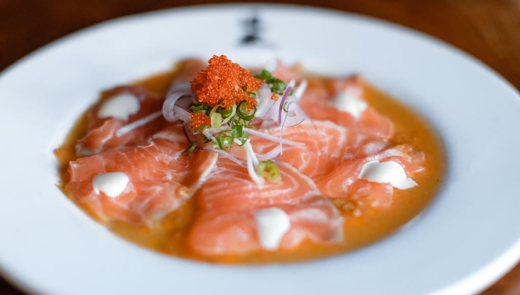 Salmon Carpaccio · Doraku favorites. Thinly sliced king salmon sashimi, red onions, garnished with a creamy ginger sauce and tobiko.

Consuming raw or undercooked meats, poultry, seafood, shellfish, or eggs may increase your risk of foodborne illness, especially if you have a medical condition.