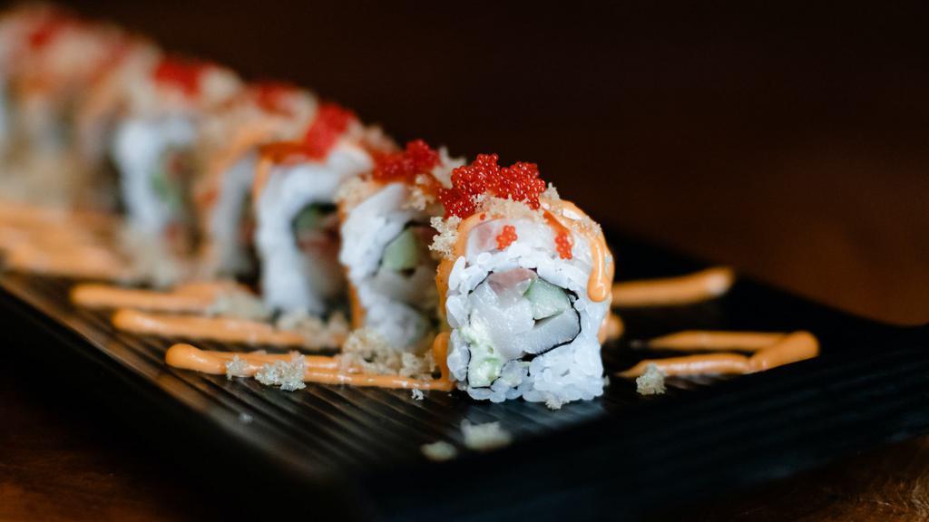 Firecracker Roll · Spicy. Hamachi, avocado, and cucumber topped with hamachi, spicy aioli, chili sauce, tempura flakes, and red tobiko.