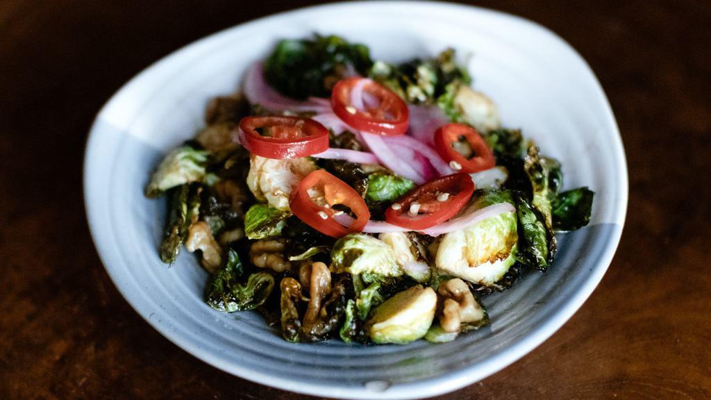 Crispy Brussels Sprouts · Vegetarian, spicy. Tossed with candied walnuts, chilies, mint, pickled onions, and Spicy Garlic Soy Sauce