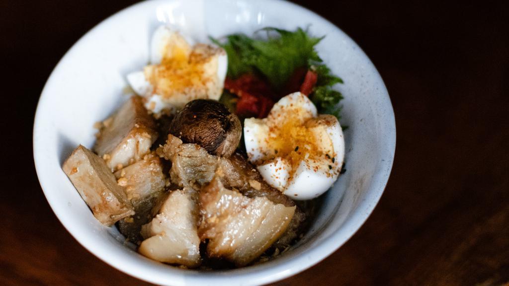 Pork Belly Yakisoba · Braised pork belly with garlic, cabbage, mushrooms, and soba noodles topped with soft boiled egg, shiso, and pickled ginger.