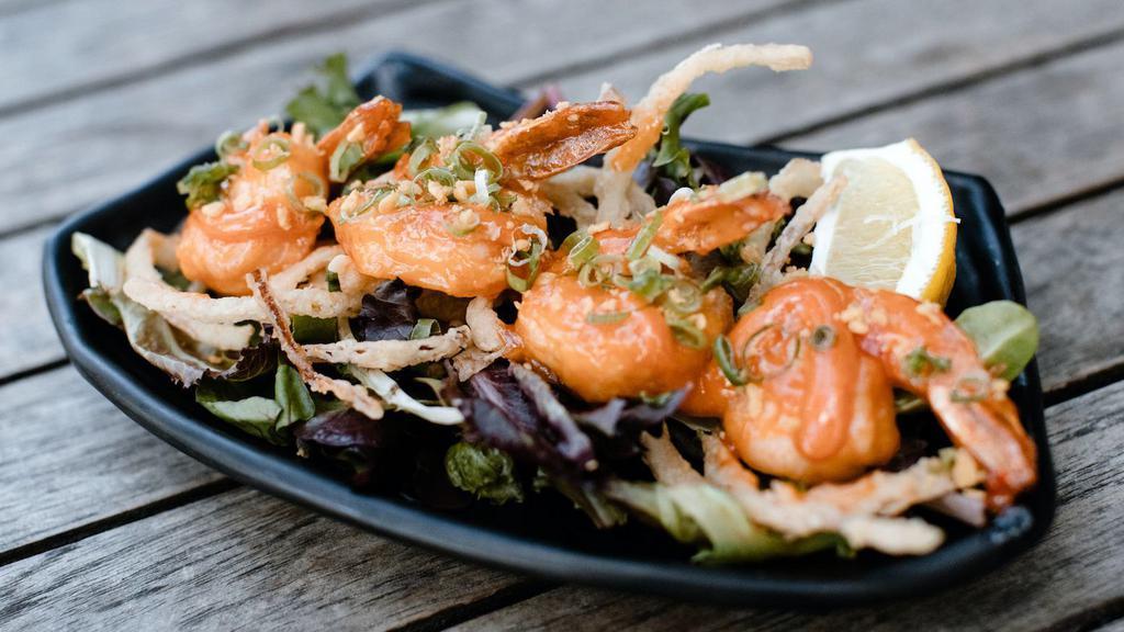 Spicy Garlic Prawns · Spicy. Flash fried served over local field greens with a sweet chili soy and spicy garlic aioli topped with Kaiware sprouts and garlic chips.