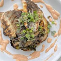 Grilled Branzino · Roasted cabbage, swiss chard & grilled mushrooms with Cajun yogurt. Contains dairy.