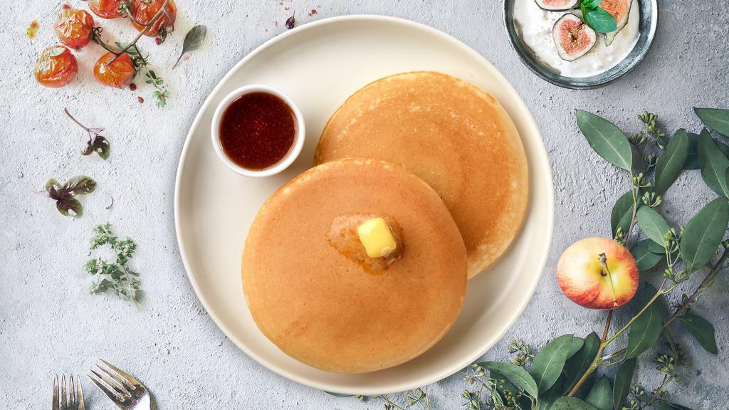 Patty'S Vegan Pancake · Two buckwheat pancakes with maple syrup and powdered sugar.
