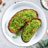 Shroomy Guac Toast · Smashed avocado on whole wheat toast topped with sauteed mushrooms and chives.
