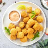 Tot Of The Morning · (Vegan) Shredded Idaho potatoes formed into tots, battered, and fried until golden brown.