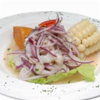 Ceviche De Pescado · Diced Fish Marinated in Lime Juice and Onions, Served with Peruvian Corn and Sweet Potato.