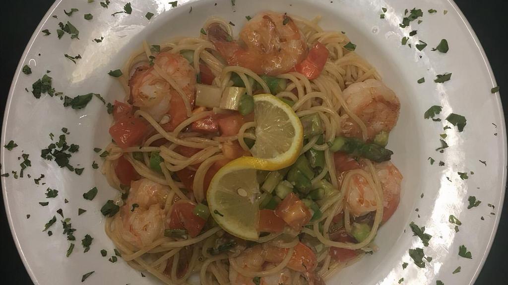 Shrimp Scampi · With tomatoes and scallions in a lemon-garlic and wine sauce
over pasta.
