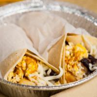 Veggie Breakfast Tacos · Two tacos with eggs, spinach, onions, cheese and black refried beans. Soft shell tacos are d...