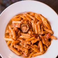 Warehouse Chicken Riggies · Tender chunks of chicken, bell peppers, onions and penne pasta tossed in a creamy SPICY toma...
