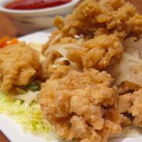 Crispy Calamari · Crispy fried calamari served with cooked onions, lettuce, and pickled carrots. Served with V...