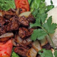 Beef Cubes With White Rice · Marinated beef cubes, lettuce, onions and tomatoes with white rice.