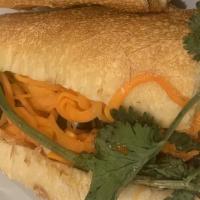 Vegetarian Tofu Sandwich · Tofu in savory garlic sauce, pickled carrots, cilantro, and cucumber in a toasted baguette.