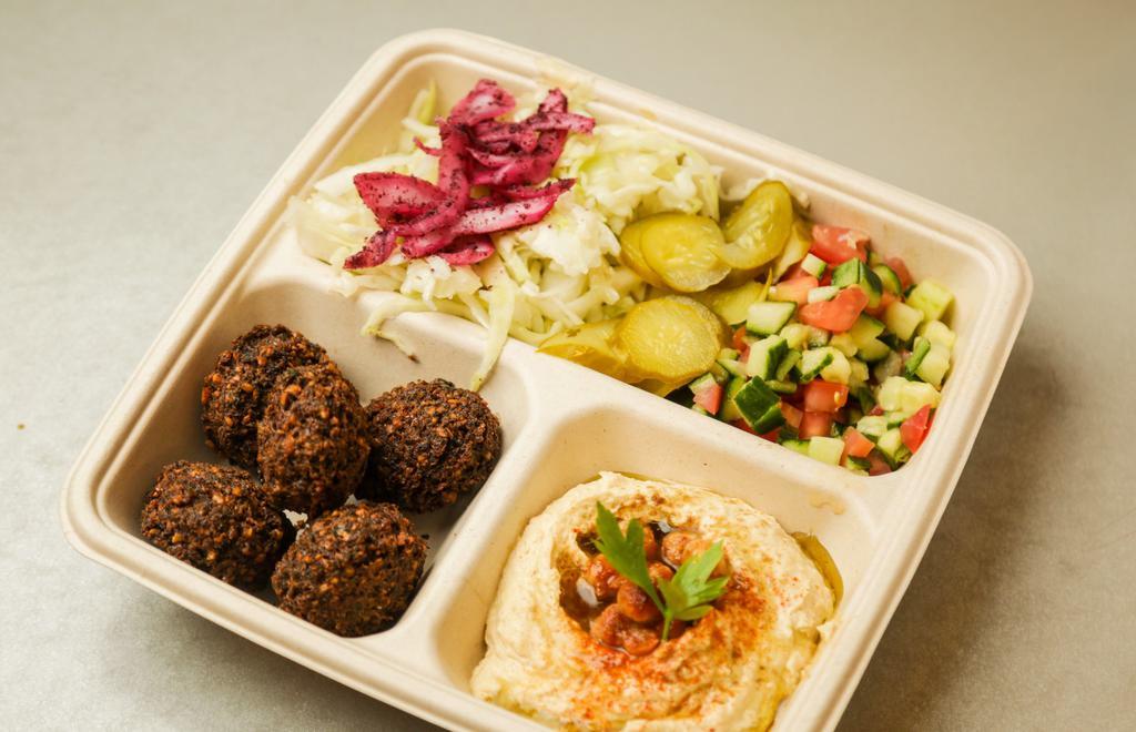 Classic Falafel Platter · Hummus, israeli chopped salad (cucumber, tomato, red onion, lemon juice, and Evoo), white cabbage, pickles, and sumac onion topped with amba' and tahini. Comes with one pita of your choice.