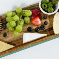 Cheese Plate · Three cheeses, bread, crackers, fruit, olives.