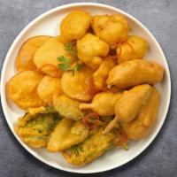 Taste Of Mix Pakora  · Assorted vegetables dipped in a light batter and fried until golden brown.